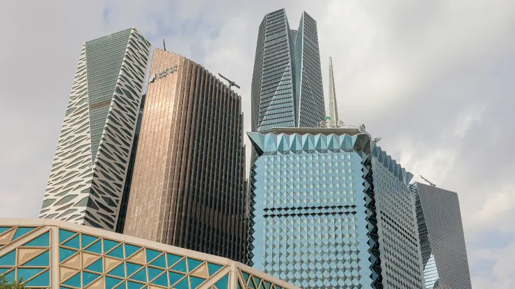 The KAFD World Trade Center, Riyadh Bank skyscraper office building, Public Investment Fund (PIF) tower, and the Saudi National Bank (SNB) headquarters, left to right, beyond the King Abdullah Financial District Conference Center in the King Abdullah Financial District (KAFD) in Riyadh, Saudi Arabia, on Tuesday, Dec. 6, 2022. The Saudi Arabian tourism ministry is targeting 12 million foreign tourists this year, with tourism on track to contribute about 4% of economic output, Tourism Minister Ahmed Al Khatee
